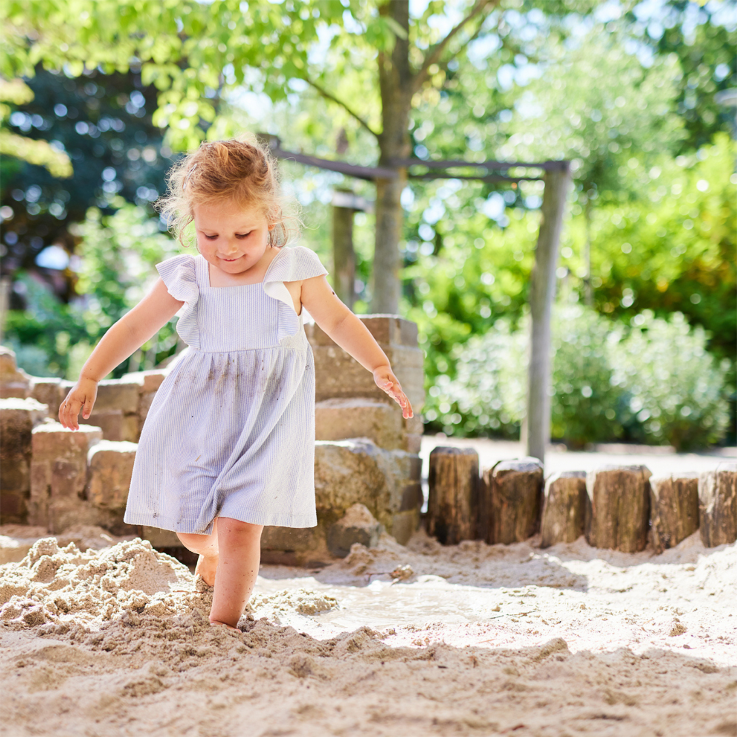 girl playing in sandbox