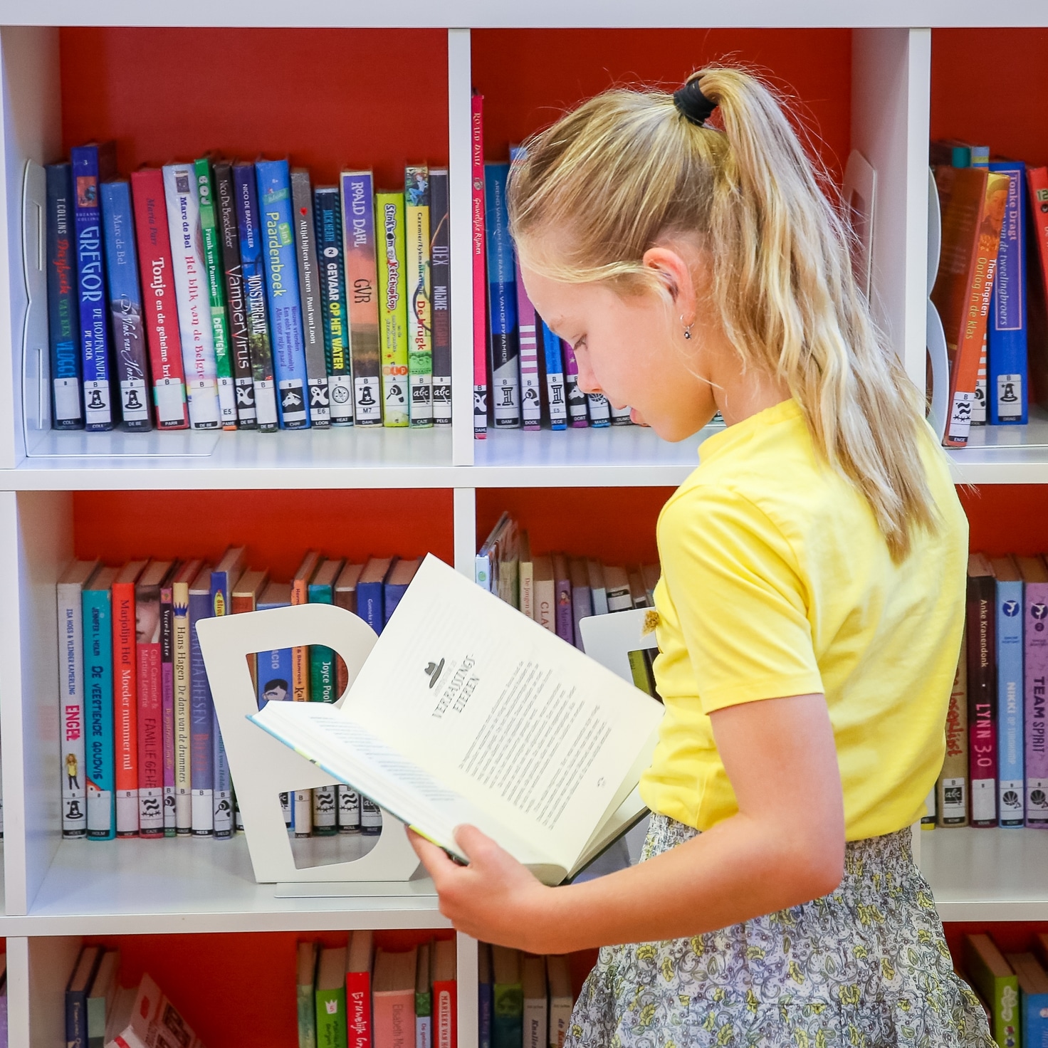 girl reading a book in library